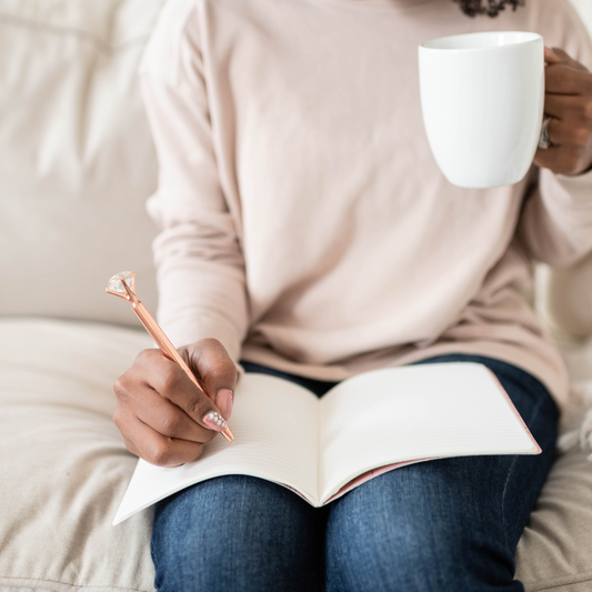 Professional woman using a Planned and Proper planner to time-block her day.