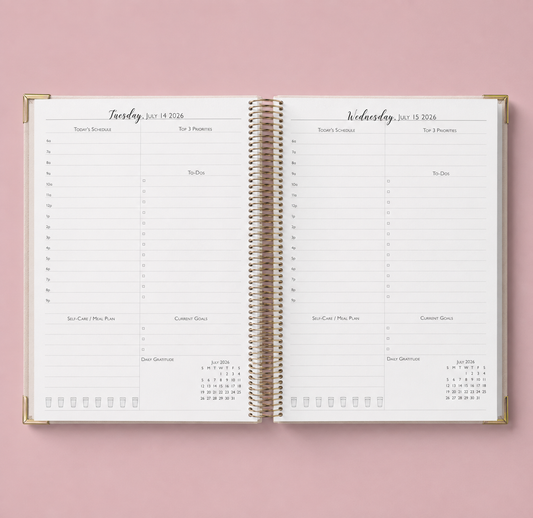 An open spiral-bound daily planner pages with gold-toned binding.